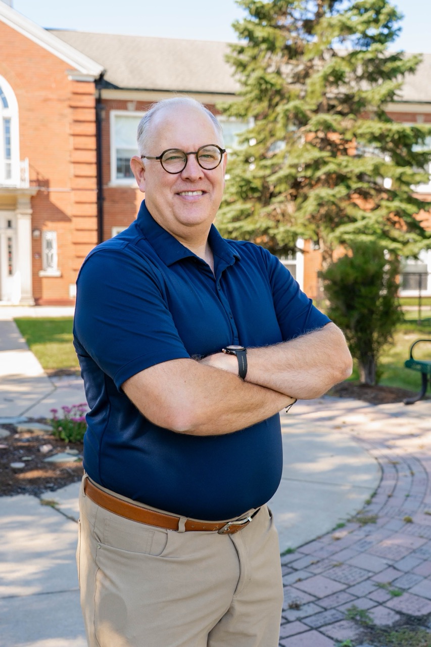 Bill in front of school